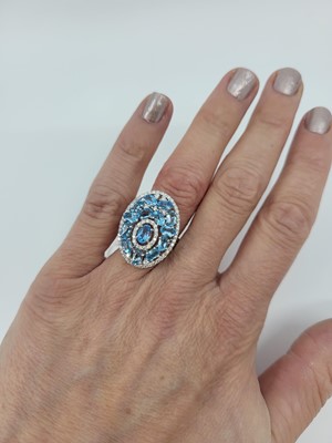 Lot 266 - A TOPAZ AND DIAMOND CLUSTER RING, set in 18ct...