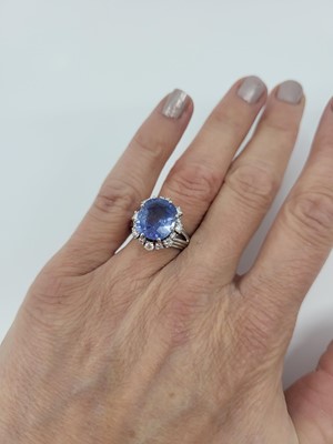 Lot 267 - A SAPPHIRE AND DIAMOND CLUSTER RING, the oval...