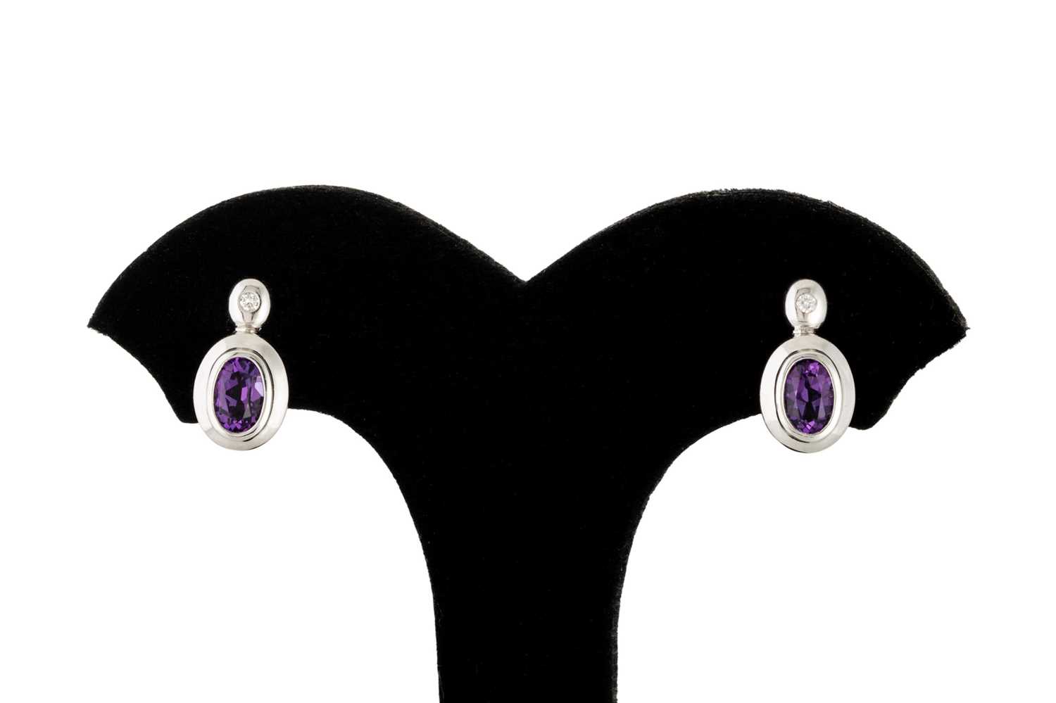 Lot 102 - A PAIR OF AMETHYST EARRINGS, bezel set, the...
