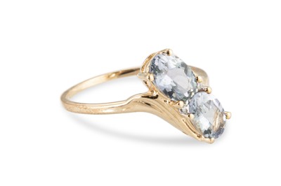 Lot 106 - A TOPAZ CLUSTER RING, of cross over style, the...