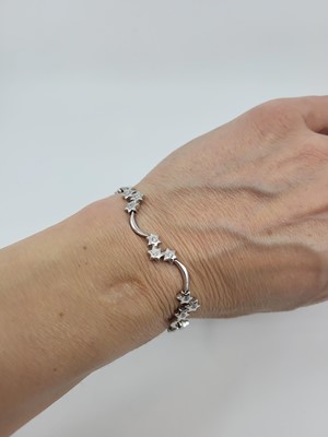 Lot 138 - A DIAMOND SET BRACELET, the brilliant cut...