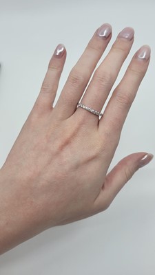 A DIAMOND SET FULL ETERNITY RING, the round...