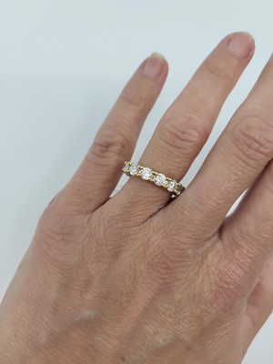 Lot 94 - A DIAMOND SET FULL ETERNITY RING, the round...