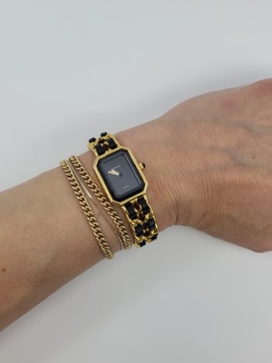 Lot 233 - A LADY'S CHANEL GOLD PLATED QUARTZ WRISTWATCH,...