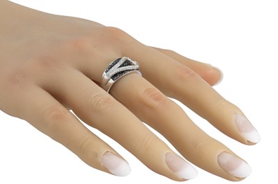 Lot 26 - A BLACK AND WHITE DIAMOND DRESS RING, pavé set...
