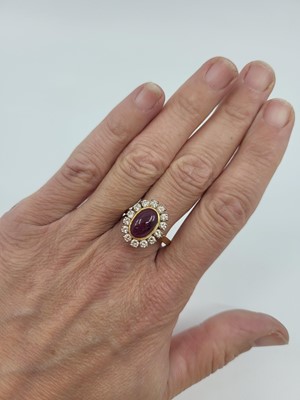 Lot 75 - A GEMSET AND DIAMOND SET RING, the oval...
