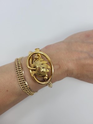 Lot 41 - A VICTORIAN GOLD PLATED SHAPED BANGLE, of...