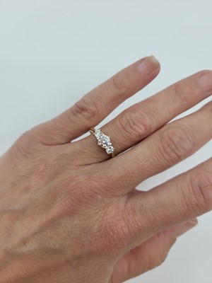 Lot 192 - A DIAMOND THREE-STONE RING, the round...