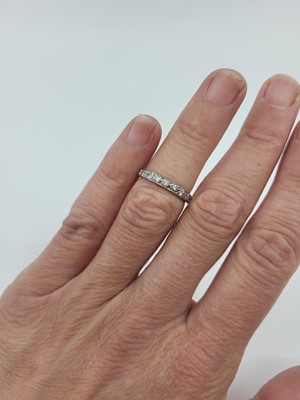 Lot 70 - A DIAMOND SET FULL BANDED ETERNITY RING,...