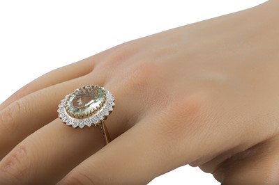 Lot 53 - A DIAMOND AND GREEN QUARTZ DRESS RING, the...