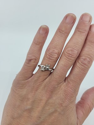 Lot 245 - A DIAMOND TWO-STONE RING, the toi et moi dress...