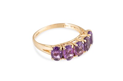 Lot 59 - AN AMETHYST FIVE STONE RING, the oval cut...