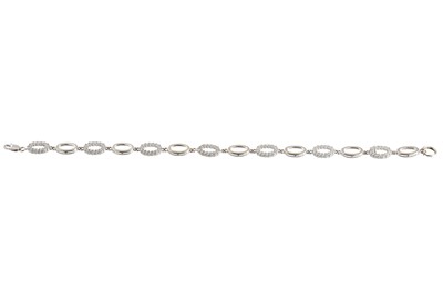 Lot 67 - A WHITE GOLD GEM-SET BRACELET, of oval linked...