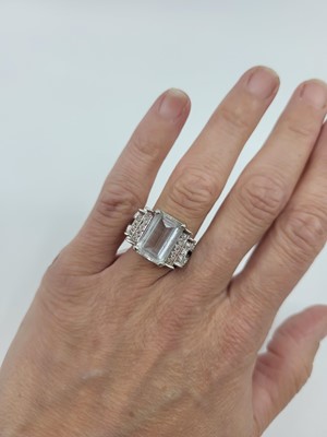 Lot 77 - A TOPAZ AND DIAMOND RING, the rectangular...