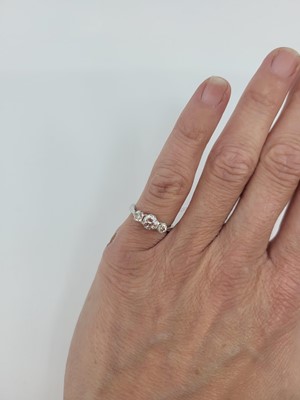 Lot 91 - A THREE-STONE DIAMOND RING, the round...