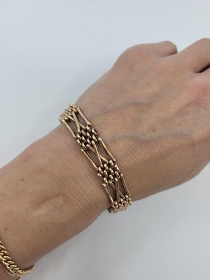 Lot 125 - A 9CT ROSE GOLD GATE BRACELET, with padlock...