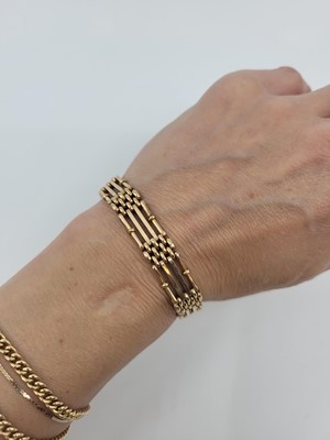 Lot 126 - A 9CT ROSE GOLD GATE BRACELET, with lobster...