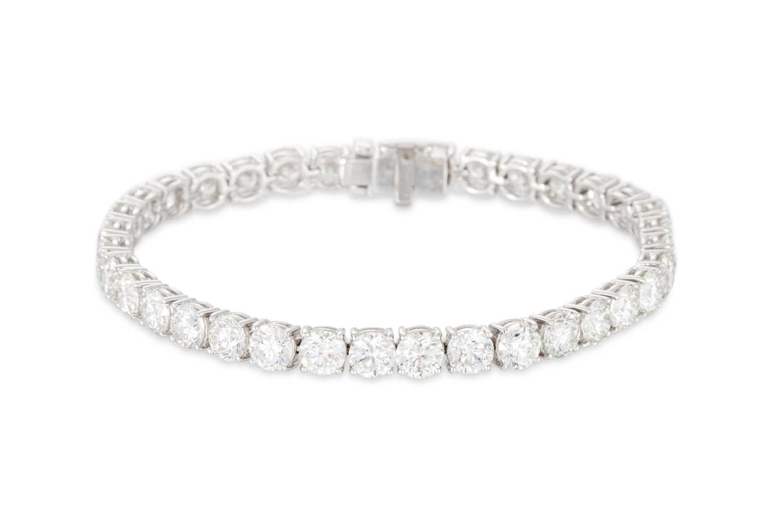 Lot 327 - A DIAMOND LINE BRACELET, the brilliant cut...
