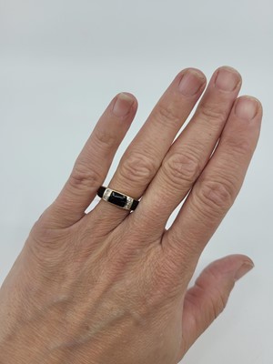 Lot 269 - A DIAMOND SET BLACK ENAMELLED RING, mounted in...