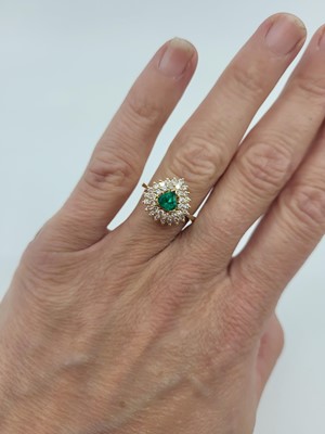 Lot 270 - AN EMERALD AND DIAMOND CLUSTER RING, the pear...