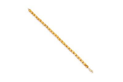 Lot 25 - A CITRINE SET LINE BRACELET, the oval citrines...