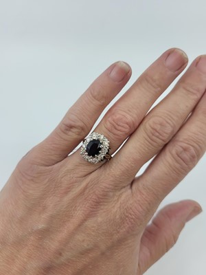 Lot 80 - A SAPPHIRE AND DIAMOND CLUSTER RING, the...