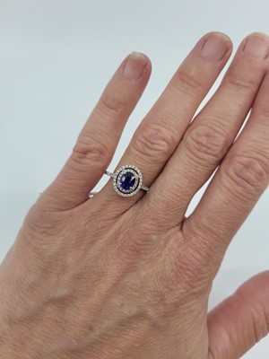 Lot 273 - A DIAMOND AND SAPPHIRE CLUSTER RING, the oval...
