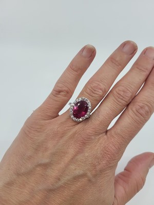 Lot 277 - A PINK TOURMALINE AND DIAMOND RING, the oval...