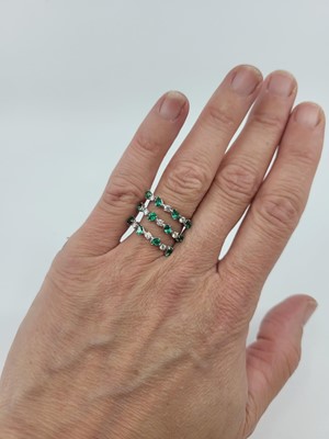 Lot 278 - AN EMERALD AND DIAMOND RING, of wrap-around...