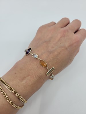 Lot 280 - A GEM-SET BRACELET, the vari cut stones collet...