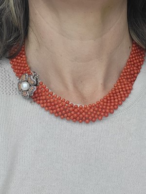 Lot 281 - A CORAL BEADED CHOKER NECKLACE, to a floral...