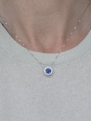 Lot 307 - A SAPPHIRE AND DIAMOND CLUSTER PENDANT, the...