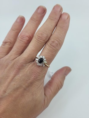 Lot 83 - A SAPPHIRE AND STONE SET CLUSTER RING, the...