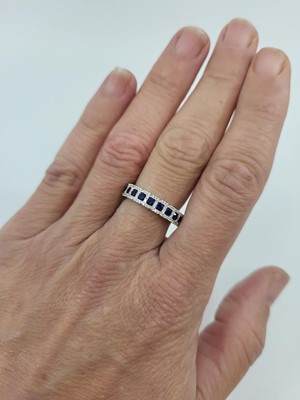 Lot 108 - A DIAMOND AND SAPPHIRE HALF ETERNITY RING, the...