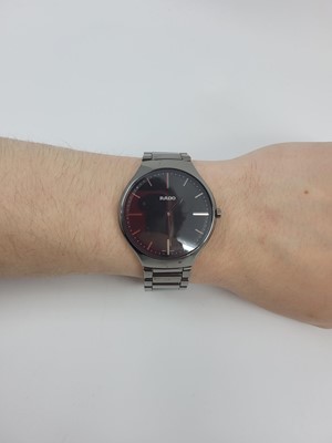Lot 397 - A GENT'S CERAMIC RADO WRISTWATCH, black dial,...