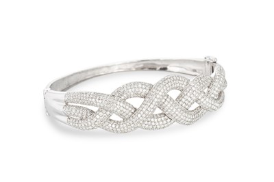 Lot 202 - A DIAMOND BANGLE, mounted in white gold, of...
