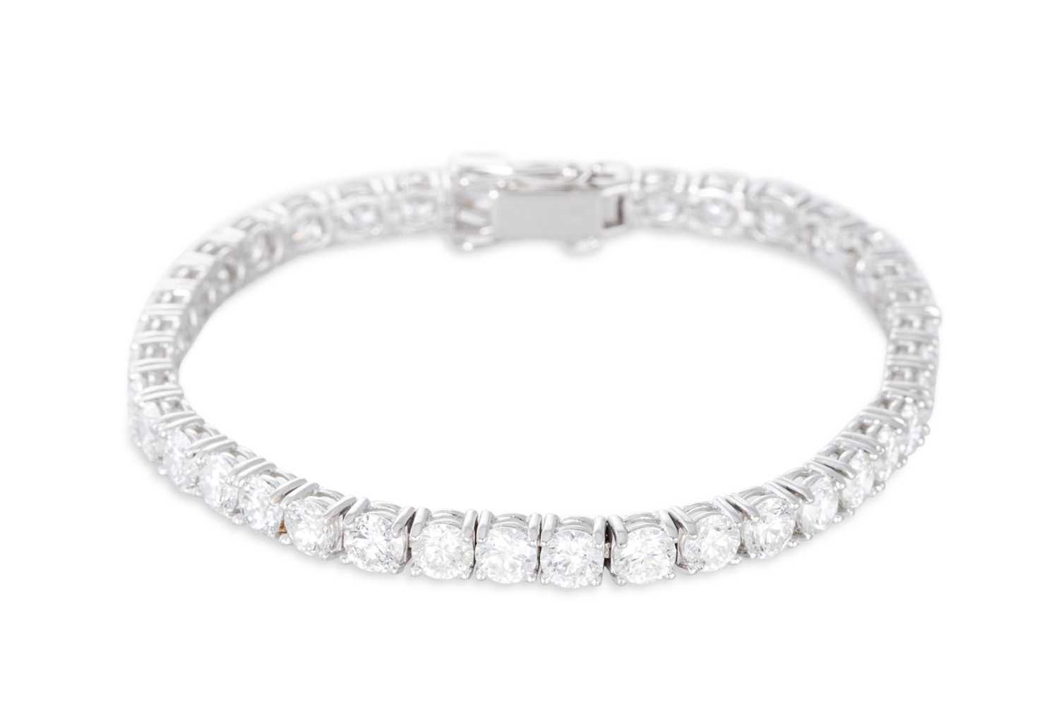 Lot 346 - A DIAMOND LINE BRACELET, the brilliant cut...