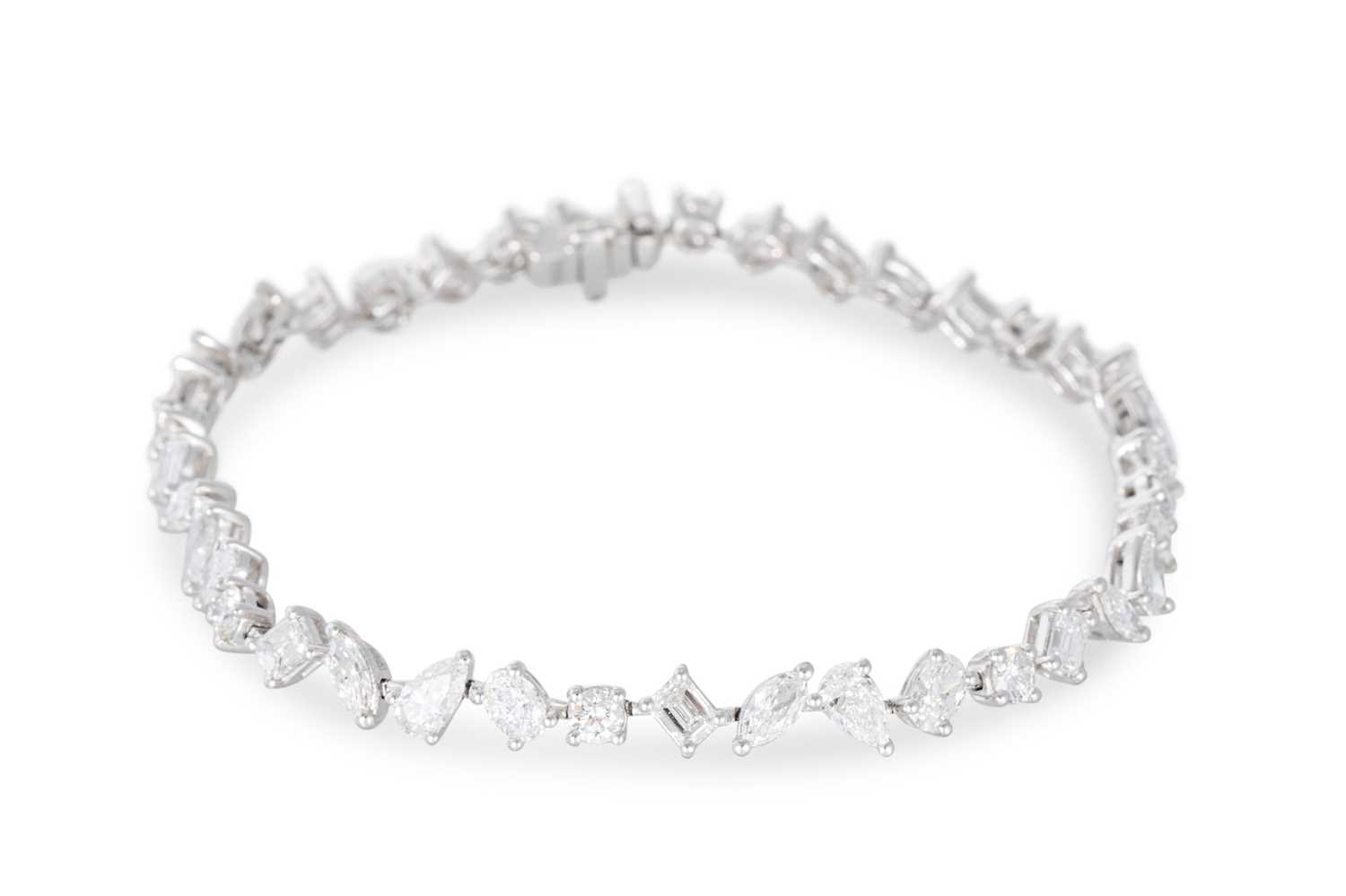 Lot 347 - A MIXED CUT DIAMOND LINE BRACELET, set with...