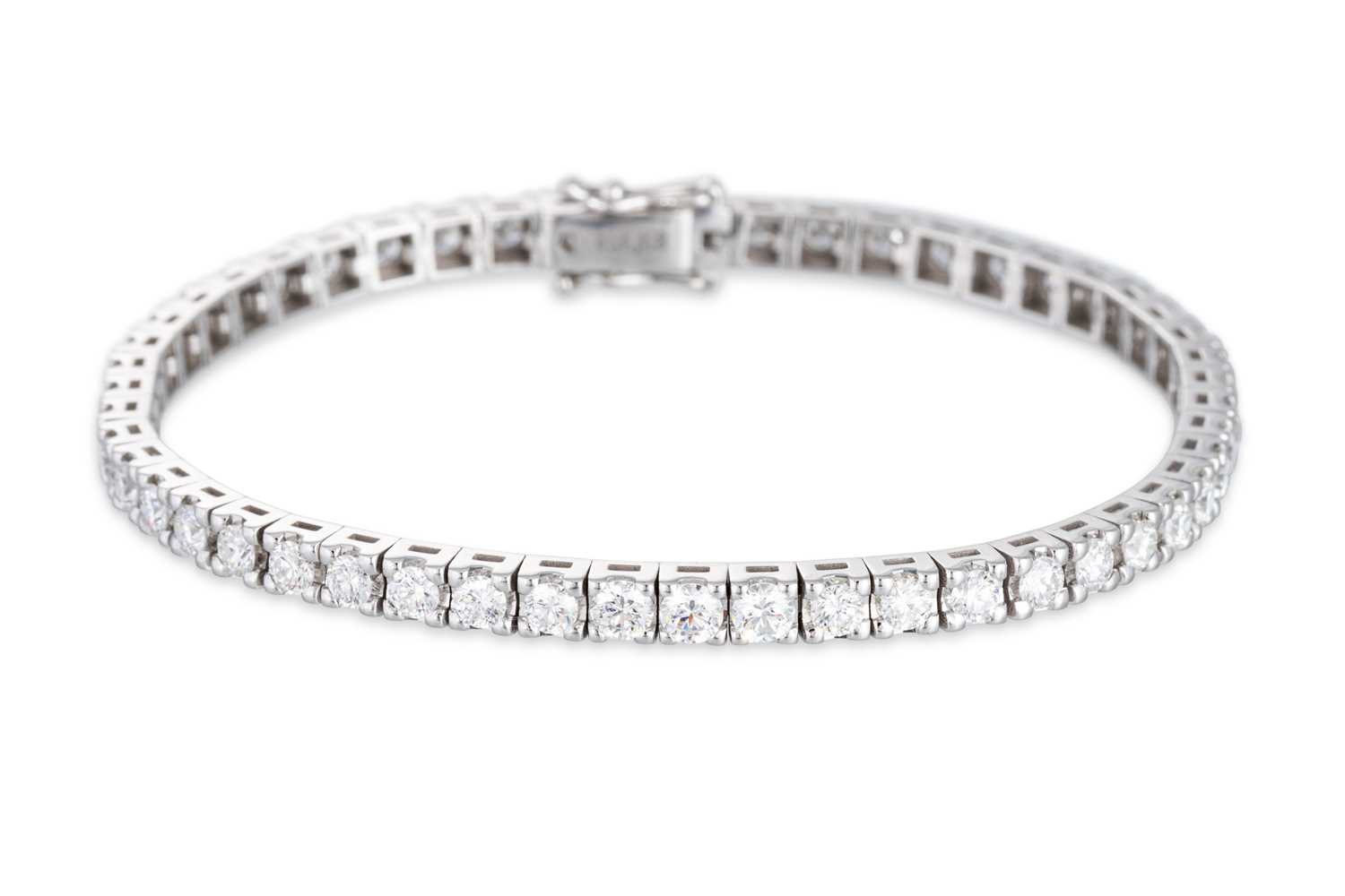 Lot 284 - A DIAMOND LINE BRACELET, the brilliant cut...