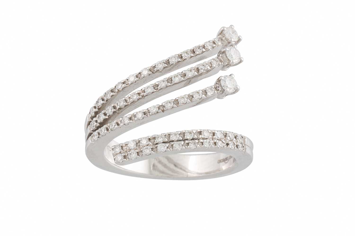 Lot 259 - A DIAMOND FOUR ROWED RING, of crossover design,...