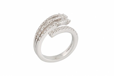 Lot 259 - A DIAMOND FOUR ROWED RING, of crossover design,...