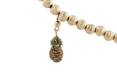 Lot 267 - A GOLD BEADED BRACELET, suspending enameled...