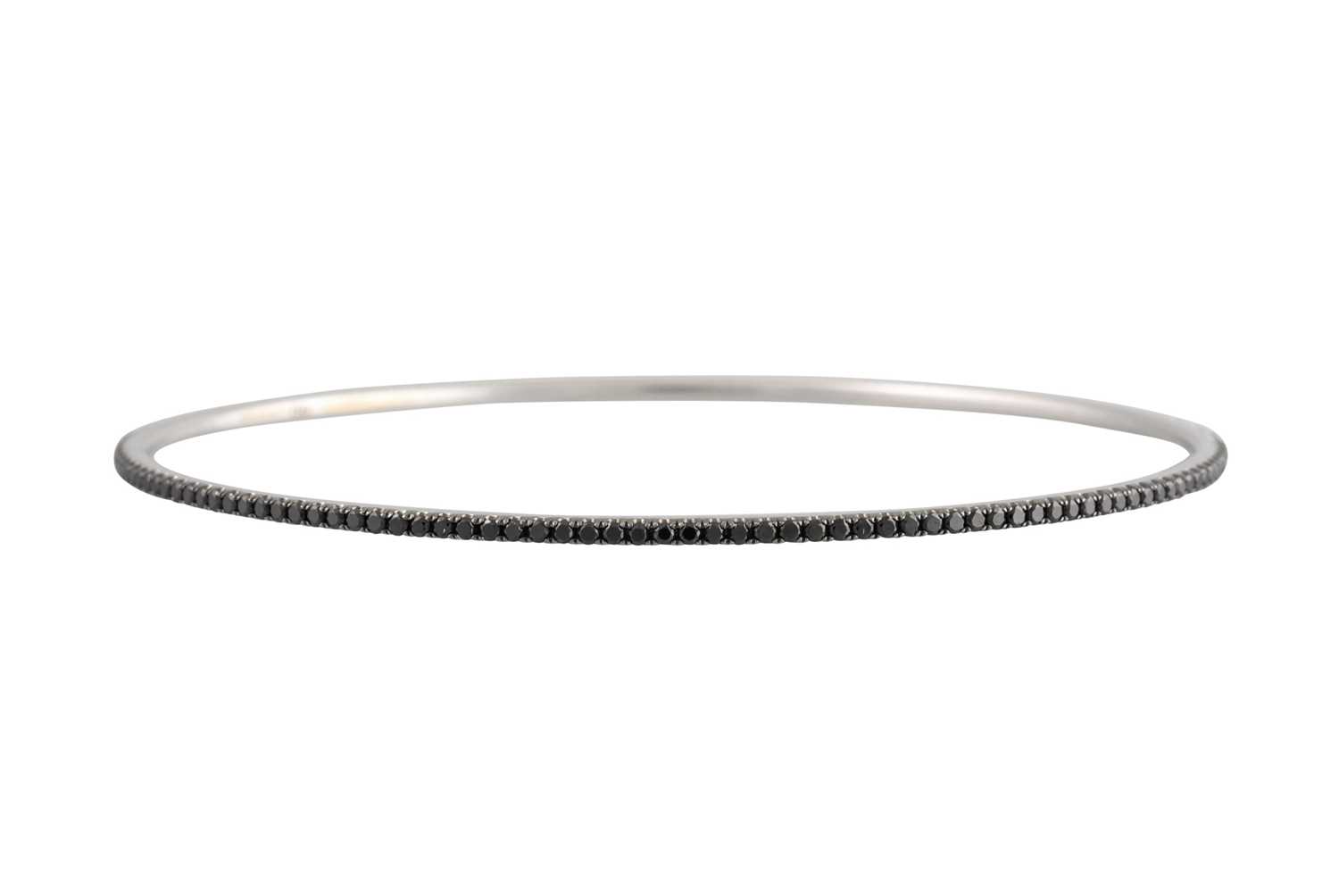 Lot 268 - A BLACK DIAMOND BANGLE, the circular diamonds...