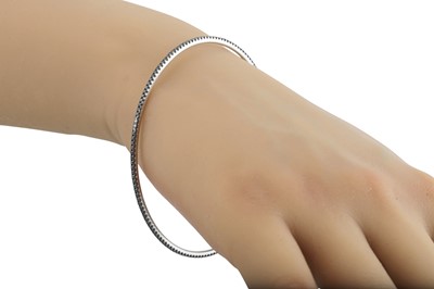 Lot 268 - A BLACK DIAMOND BANGLE, the circular diamonds...