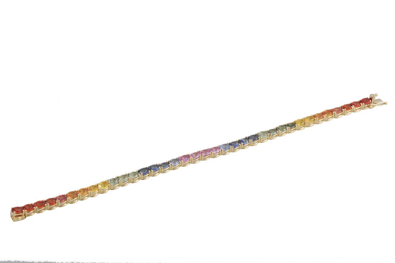 Lot 249 - A MULTI COLOURED SAPPHIRE LINE BRACELET, the...