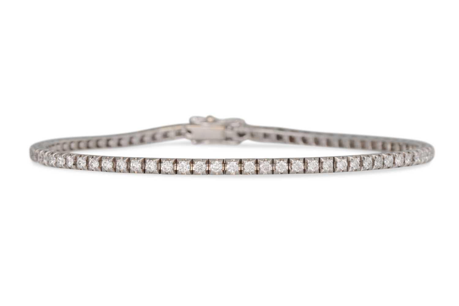 Lot 232 - A DIAMOND LINE BRACELET, the brilliant cut...